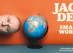 Jack Dee sideways next to a globe