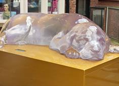 Pink resin statue of a sleeping puppy