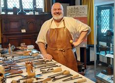 Tudor Surgeon with a table of surgical instruments