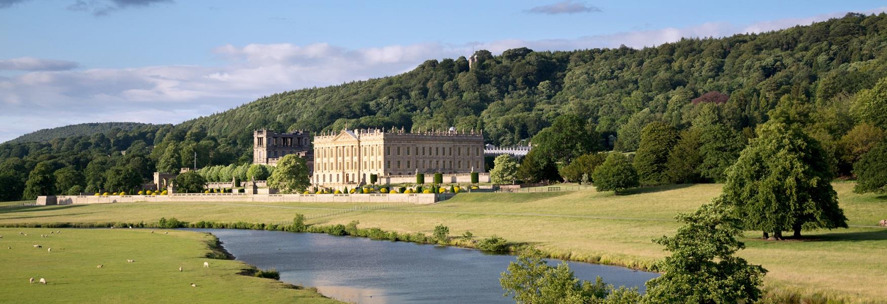 View of Chatsworth from across the river with sheep grazing