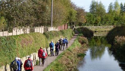 A group of people walking along the path next to Chesterfield Canal