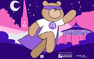 Cartoon of a teddy bear dressed as a superhero with the Crooked Spire in the distance