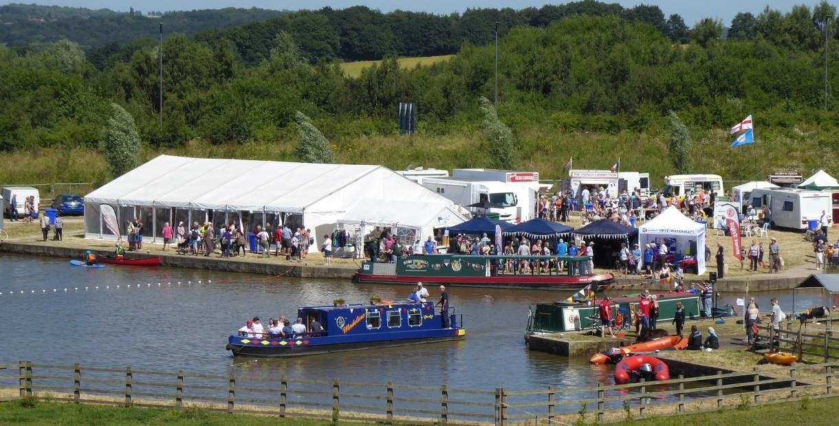 Canal boats and marquees filled with people