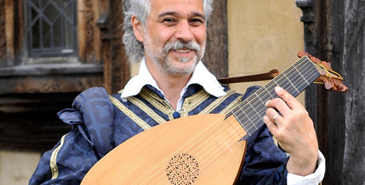 Dante Ferrara in Tudor clothing playing a lute