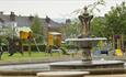 Fountain in Eastwood Park with Children's play area in the background