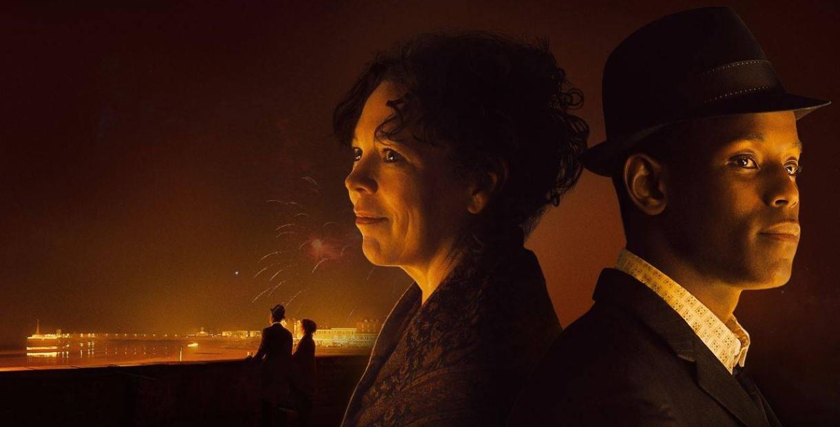 Olivia Coleman and Michael Ward facing away from each other with a dark skyline in the background