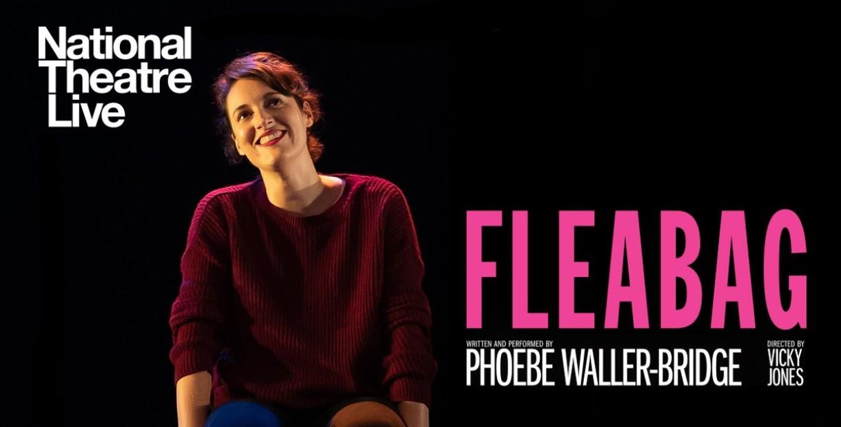 Phoebe Waller-Bridge sat on dark stage smiling