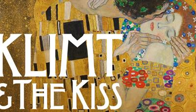 'The Kiss' by Gustav Klimt - an Art Nouveau oil painting of a man kissing a woman's cheek