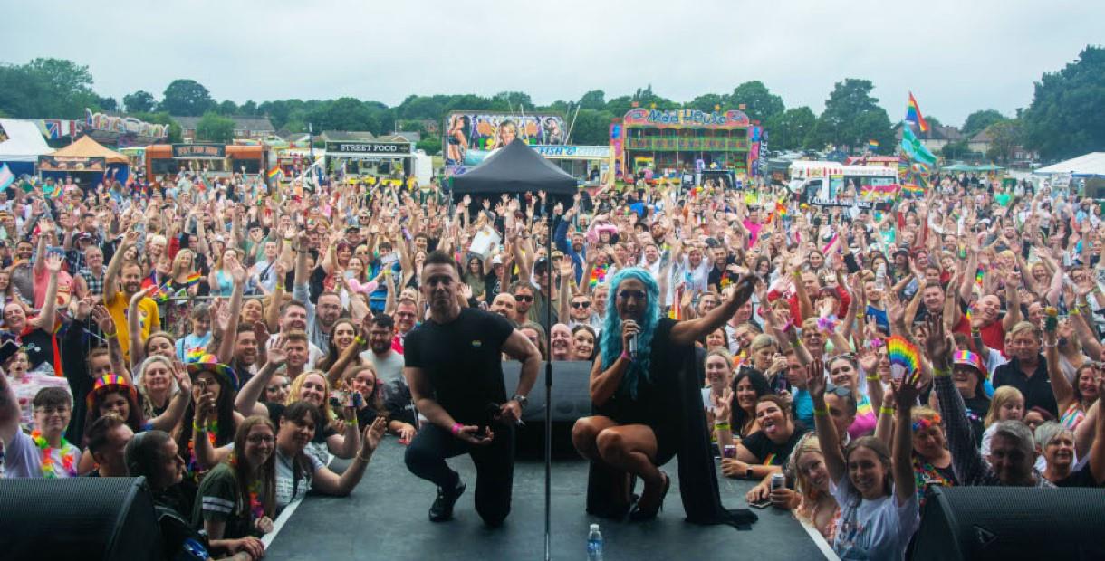 Performers posing with the crowd at Chesterfield Pride