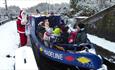 Santa boarding the Madeline narrowboat in snow