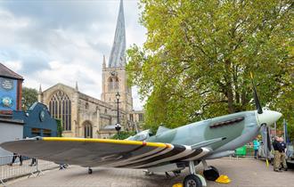 Full size replica Spitfire at Chesterfield 1940s Market with 'Crooked Spire' Church in the background