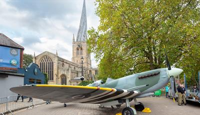 Full size replica Spitfire at Chesterfield 1940s Market with 'Crooked Spire' Church in the background