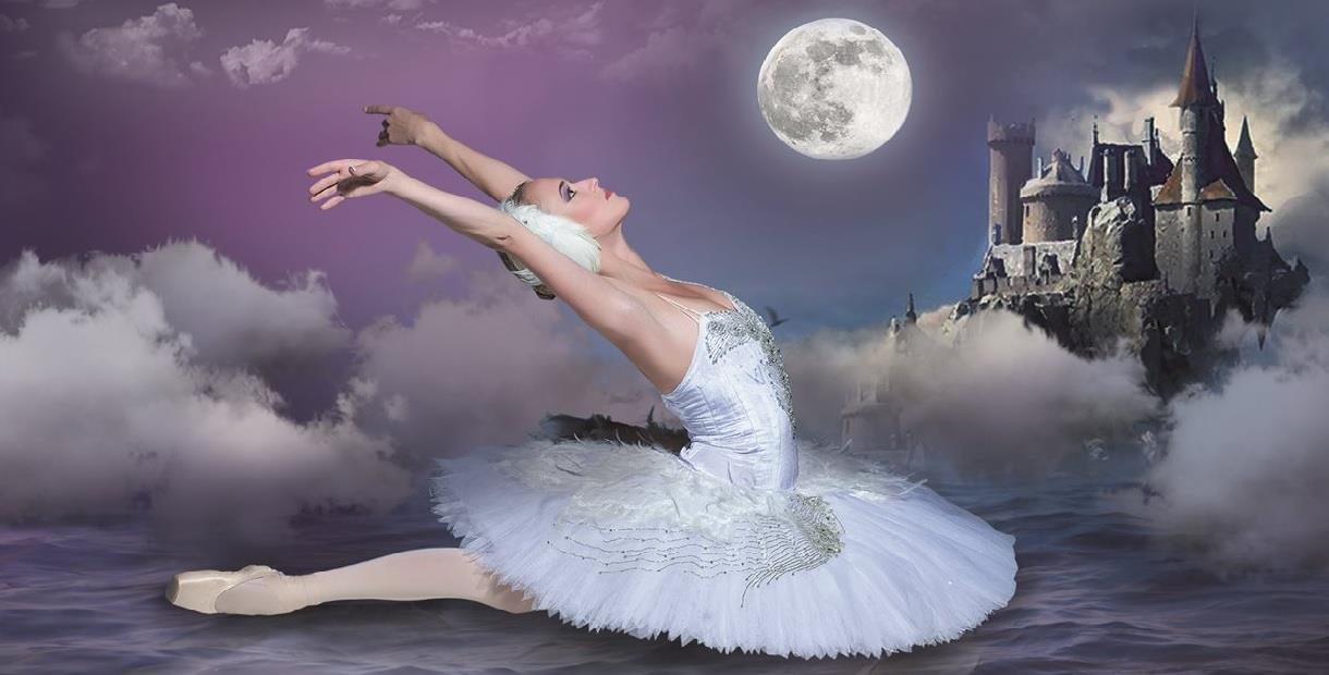 A single ballet dancer in the classic swan pose on what appears to be water, with a purple hued night sky behind her. There are atmospheric clouds aro