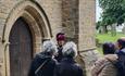 Baroness Bolsover talking outside a church door