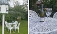 White metal patio furniture next a dove house and a bottle of prosecco with two glasses on the table