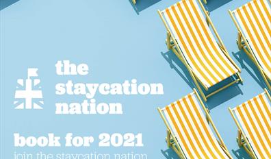 The Staycation Nation advert, blue background with yellow striped deckchairs