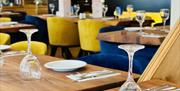 Doga Restaurant interior with blue and yellow chairs