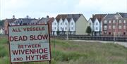 A sign reading "All Vessels Dead Slow between Wivenhoe and Hythe"