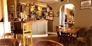 Inside of the Foresters Arms, bar and table and chairs.