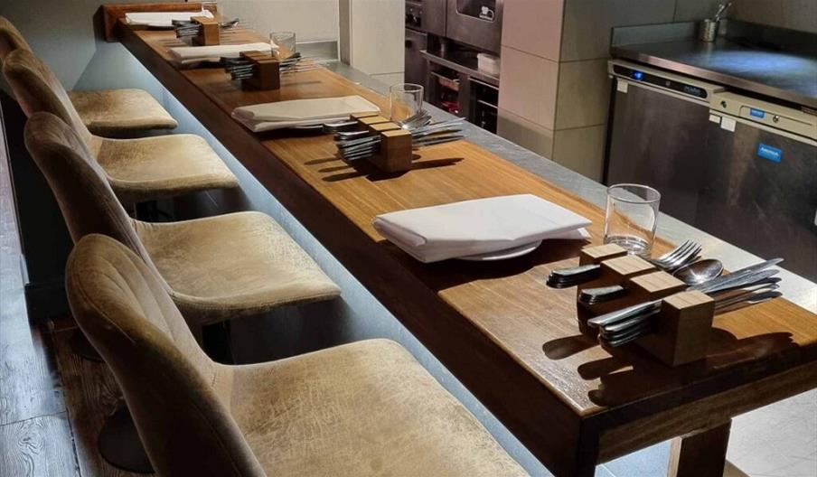 Kitchen Bar with plates laid and cutlery