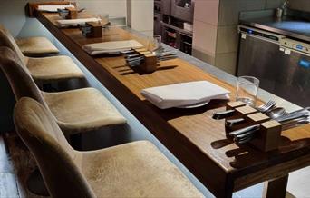 Kitchen Bar with plates laid and cutlery