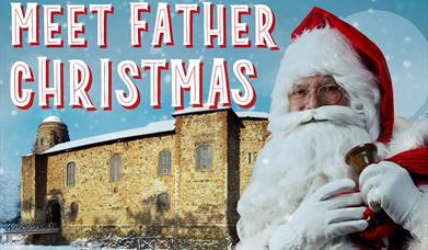 An image of Santa in front of a snow covered Colchester Castle