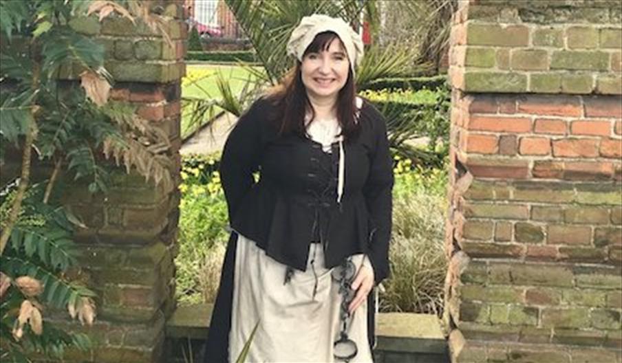 A tour guide dressed as 'Aggie - the jailer's wife'