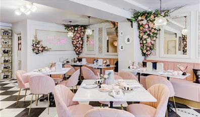 Inside T at The George with pink chairs and pink flower garlands