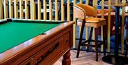 Pool table and chair in the bar area