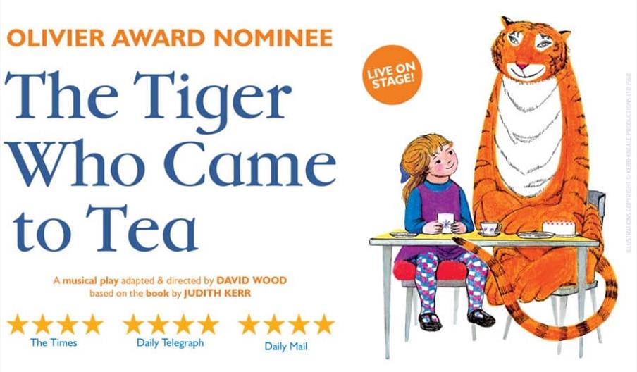 The Tiger who came to tea. Tiger sitting at a table with a young girl