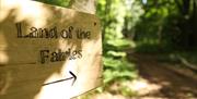 Wooden Sign post saying 'Land of the Fairies'
