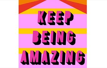 a brightly coloured placard reading 'keep being amazing'