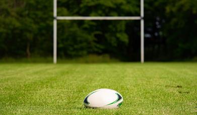 White rugby ball against a goal