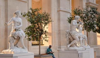 White marble statues outside museum