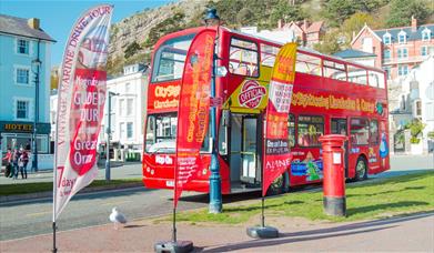 City Sightseeing bus parked by its advertising banners