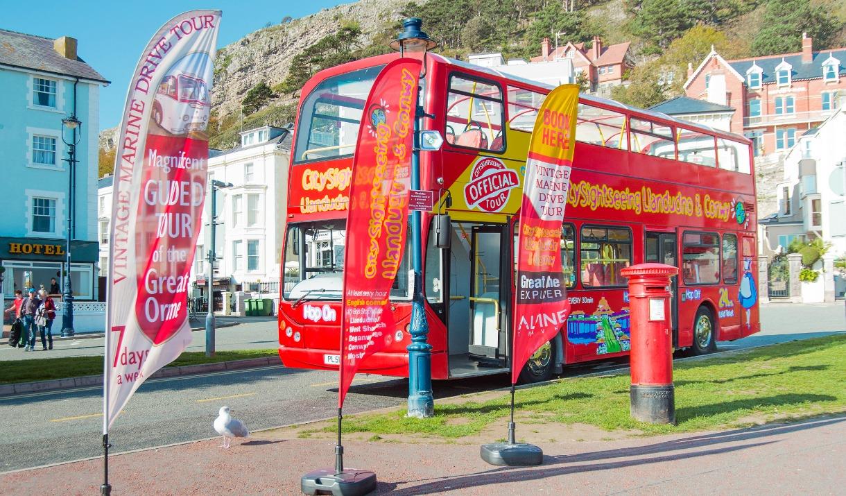 City Sightseeing bus parked by its advertising banners