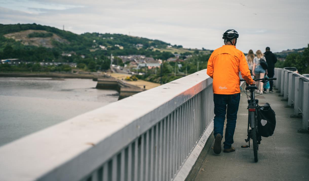 Cyclist walking on Conwy Bridge