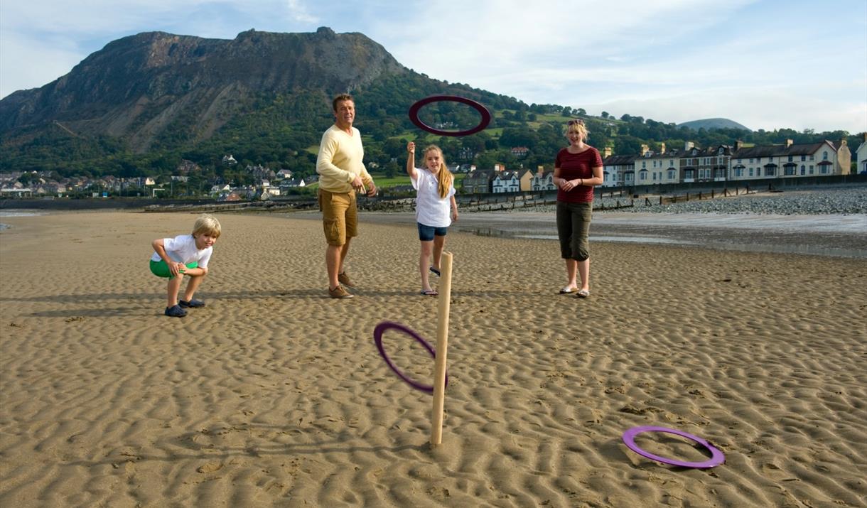 Family playing quoits on Llanfairfechan Beach