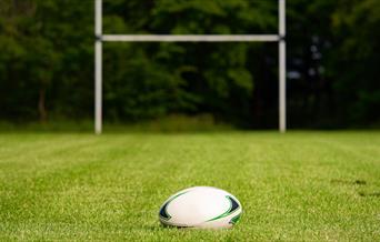 White rugby ball against a goal