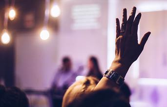 Hand raised to ask a question
