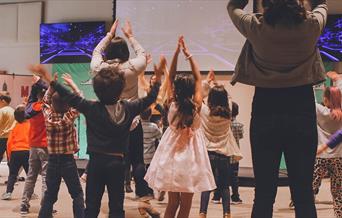 Kids participating in a theatre workshop