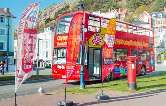 City Sightseeing bus parked by its advertising banners