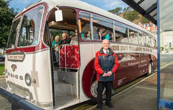 Bus driver stood outside the Marine Drive tour bus