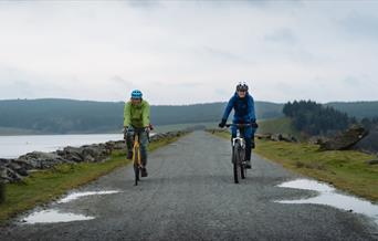 Two cyclist riding side by side