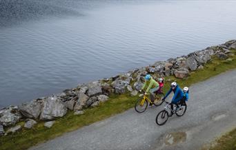 Two cyclists on lake side path