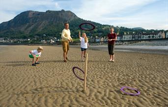 Family playing quoits on Llanfairfechan Beach