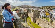 People looking into the interior of Conwy Castle from the turrets