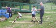 Family group building a raft