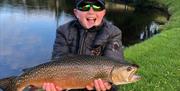 Boy holding large fish