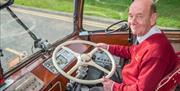 Bus driver behind the wheel of the coach